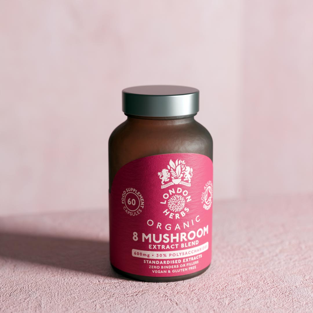 Bottle of Organic 8 Mushroom Extract Blend Complex capsules on a plaster surface.